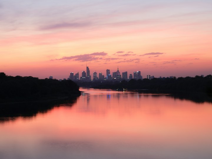 Warsaw skyline across the Vistula at dusk